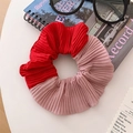 Detail of red and pink pleated fabric hair scrunchie in a lifestyle desk setting - Red Patchwork Pleated