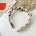 Detail of champagne twisted woven headband with non-slip comb teeth and handmade label - Champagne