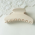 Detail view of large cream fan-shaped hair claw clip with glossy finish on lace - Large Creamy White
