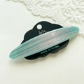 Detail view of acetate hair clip with blue and white marble texture on a display card - Mixed Blue