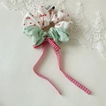 Detail of cherry print scrunchie with a red plaid bow and green fabric patchwork - Scrunchie Bow