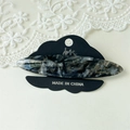 Detail of a handmade marble acetate hair clip on a premium black cloud display card - Obsidian Black