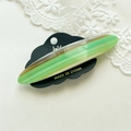 Macro view of green and brown marbled acetate hair clip with high gloss finish on lace - Mixed Green