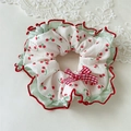 Detail of sweet cherry scrunchie with red plaid bow and green ruffled edges - Lace Trim Bow