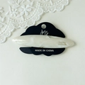 Macro detail of elegant ivory marble acetate hair clip on branded display card - White