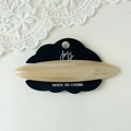 Detailed macro view of an oval acetate hair clip with a cream marble pattern finish - Milky Yellow