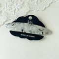Detail of elegant black and white marble acetate hair clip on presentation card with lace - Gray