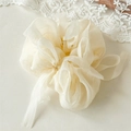 Detail of cream organza hair scrunchie with long ribbons and delicate lace background - Milky Yellow