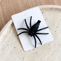 Close-up of black glittery spider hair clip for Halloween on white display card - Glitter Ghost Spider Black