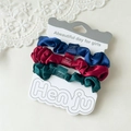 Detailed view of three satin scrunchies in navy, wine red, and forest green set - Vivid Colors
