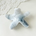 Detail of starfish hair claw clip featuring blue marble texture and glossy finish - Starfish Grey