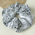 Detail view of large paisley print hair scrunchie with soft black and white fabric texture - White