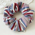 Detailed view of colorful striped scrunchie with knit texture and fabric brand label - Red Blue White Striped (Single)