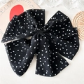 Vue détaillée d'une grande pince à cheveux à nœud noir avec motifs floraux blancs - Pince Nœud à Pois Noir