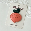 Detail of pink leather strawberry hair clip with green leaves on lace background - Carrot