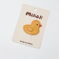 Handcrafted yellow leather duck hair clip with orange beak on a premium display card - Yellow Duck