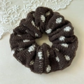 Detail of dark brown knitted scrunchie with white heart patterns and soft wool texture - Coffee Brown with White Dots
