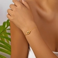 Close-up of golden Evil Eye bracelet with blue stone and white zircon pave setting - Bracelet (Copper)