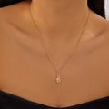 Detail of a gold teardrop zircon necklace worn by a model showing the elegant drop pendant - Water Drop Style (Gold Color)