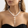 Detail of vintage tassel pearl Y-necklace and drop earrings set on female model - Set
