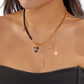 Collana a catena dorata e perline nere con grande cristallo a cuore e ciondoli stella - Nappina Stella Luna a Cuore