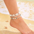 Close-up of shell, starfish and turtle charm anklets on a beach background - Anklet / Blue