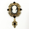 Detailed retro cameo brooch with hollow gold filigree and amber rhinestones detail - White