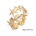 Detailed macro view showing the textured starfish and shell motifs on gold sea bangle - Gold Starfish Shell Alternating Bangle (BR26Y0096)