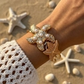 Colorful starfish open cuff bracelet with pearls and golden finish on beach background - Gold Pearl Starfish (BR26Y0029-1)