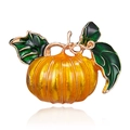 Detail of pumpkin brooch with orange enamel finish and green leaves on gold metal - Pumpkin Style (BC18Y0111)