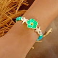 Summer beach style beaded bracelet featuring a green plumeria flower and white starfish - Polymer Clay Flower (Green)