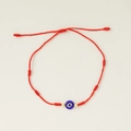 Detail of red braided 7 knots evil eye bracelet with blue bead and gold accents - Red Rope