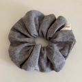 Detail showing grey ribbed knit scrunchie texture and Hand Made fabric label closeup - Gray