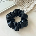 Detailed view of large black faux leather hair scrunchie with vintage glossy texture - Black