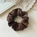 Detail of brown PU leather scrunchie showing rich vintage texture and soft folds - Brown