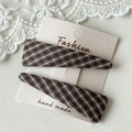 Detail of plaid fabric triangle hair clips on display card with white lace accents - Khaki Plaid