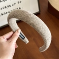 Detailed view of the camel wool fabric texture and Hand Made label on the wide headband - Khaki