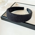 Detailed macro of black wool headband texture with handmade label inside for winter - Black