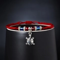 Adjustable red braided evil eye bracelet featuring a silver turtle pendant and blue beads - Turtle Style
