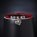 Handmade red cord bracelet featuring blue evil eye beads and a silver heart charm pendant - Heart Style