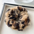 Close-up of leopard print plush scrunchie on display tray with aesthetic decoration - Light Coffee