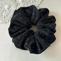 Macro detail of black polka dot fabric scrunchie showing knitted texture and high elasticity - Black Polka Dot