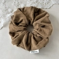 Close-up of brown wool fabric scrunchie with FMdrea white label and lace decoration - Large / Khaki