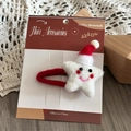 Detail of wool felt star hair clip with Santa hat on a decorative display card - Star Hat