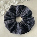 Detailed macro view of gray leopard print velvet fabric texture on a soft scrunchie - Black Double Layer
