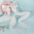 White bridal bow veil with pearls and BRIDE lettering on a soft pastel background - BRIDE Long Tulle Satin Bow (HS-J7462)