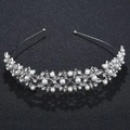 Close-up of elegant bridal headband with white pearls and sparkling crystal leaves - Silver (TS-J1994)