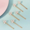Dettaglio di 6 fermagli per capelli a foglia dorata con cristalli su sfondo blu - Oro (HS-J7430G)