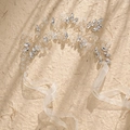 Macro detail of handmade bridal headband with silver wire, crystals, and organza ribbon - Silver