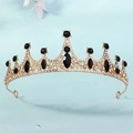 Golden baroque crown with black gemstones and white rhinestones on light blue background - Gold Black Zirconia